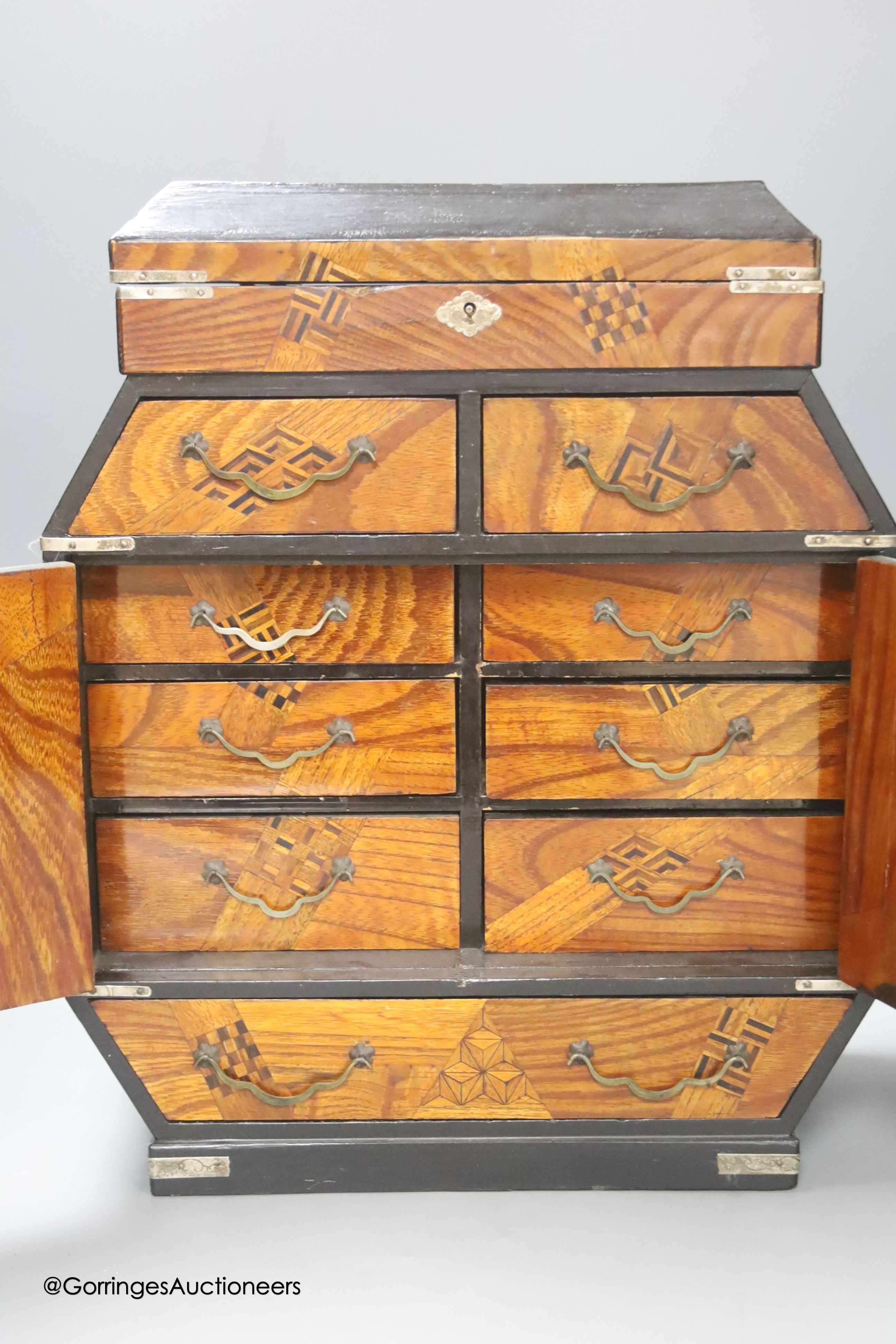 A Japanese lacquer and white metal mounted inlaid table cabinet, height 37cm